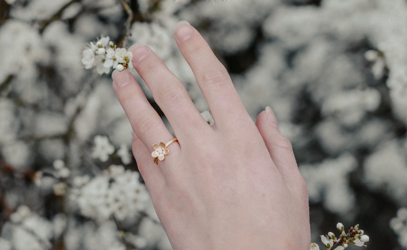 Hand wearing flower ring from Nicholas Wylde